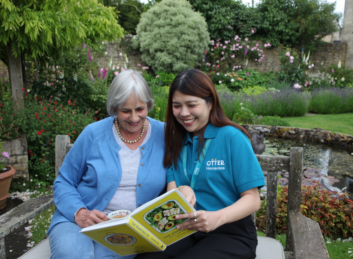 An Otter carer sharing a warm moment with a client in the garden