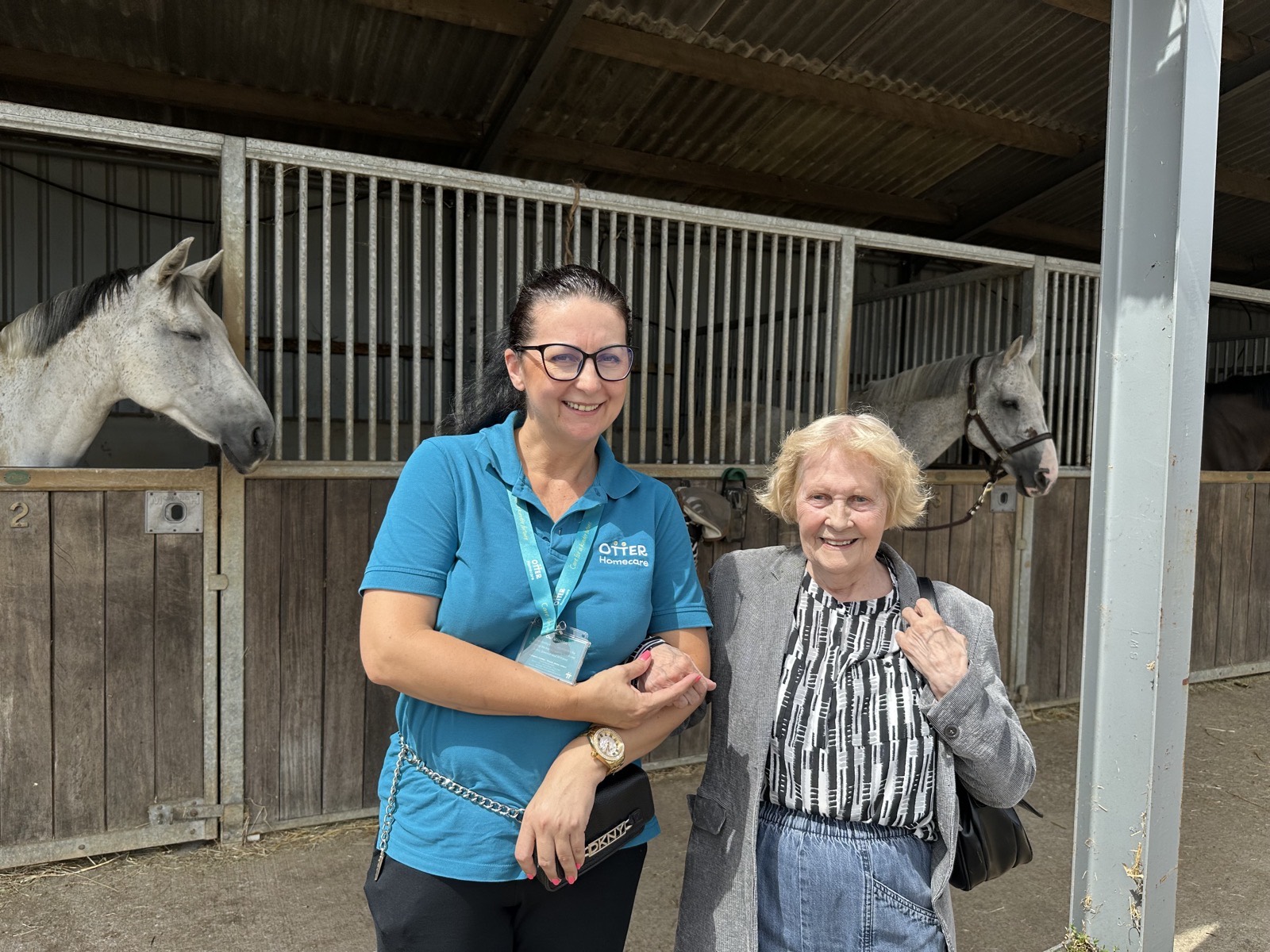 A client enjoying an Otter Happy Hour visit to pet the horses at a local stable